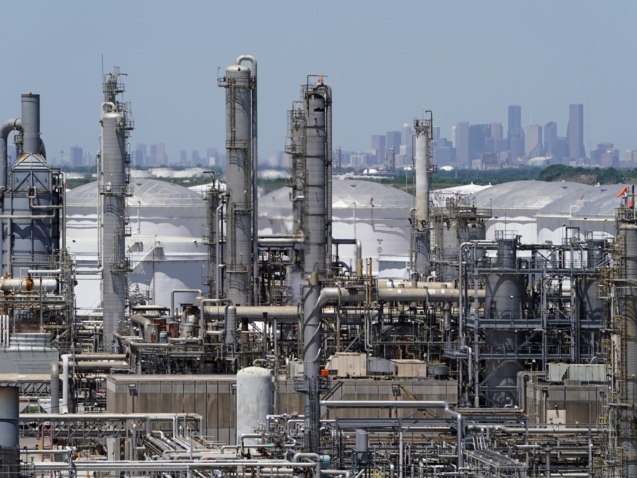 FILE - A refinery along the Houston Ship Channel is seen with downtown Houston in the background on April 30, 2020. Billions of dollars in climate and environment investments from the Inflation Reduction Act could flow to communities in the United States that have been plagued by pollution and climate threats for decades. (AP Photo/David J. Phillip, File)