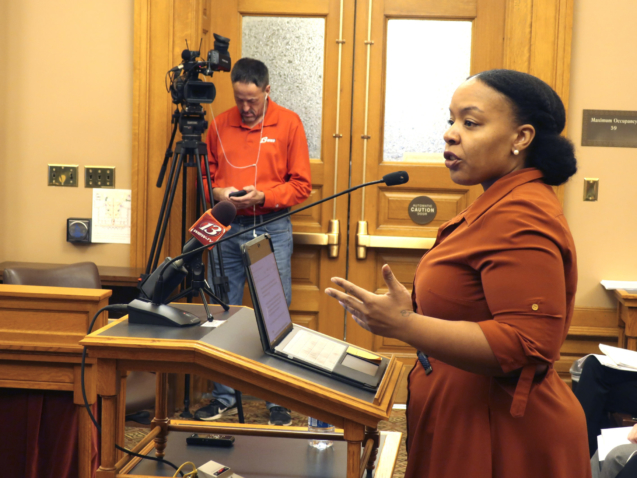 Michele Watley, founder of Shirley's Kitchen Cabinet, testifies in favor of a bill before the Kansas Legislature to ban discrimination based on hairstyles in employment, housing and public accommodations during a committee hearing, Tuesday, Jan. 28, 2020, at the Statehouse in Topeka, Kansas. Her Kansas City, Missouri, group advocates for black women and says they often feel forced to straighten their natural hair to get jobs or keep them. (AP Photo/John Hanna)