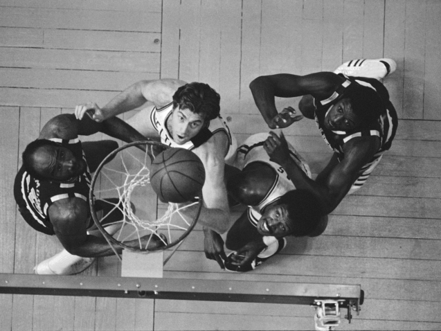 Boston Celtics Dave Cowens, center, dumps in a basket as Cleveland Cavaliers Nate Thurmond, left, and Celtics Paul Silas watch in first period of their NBA game at Boston Garden, May 7, 1976. Boston won the game, 111-99, to lead best-of-seven Eastern Conference final, 1-0. Others are unidentified. (AP Photo)