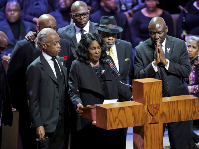 Flanked by Rev. Al Sharpton, left, her husband Rodney Wells, second from right, and attorney Benjamin Crump, right,  RowVaughn Wells speaks during the funeral service for her son Tyre Nichols at Mississippi Boulevard Christian Church in Memphis, Tenn., on Wednesday, Feb. 1, 2023.  Nichols died following a brutal beating by Memphis police after a traffic stop.  (Andrew Nelles/The Tennessean via AP, Pool)