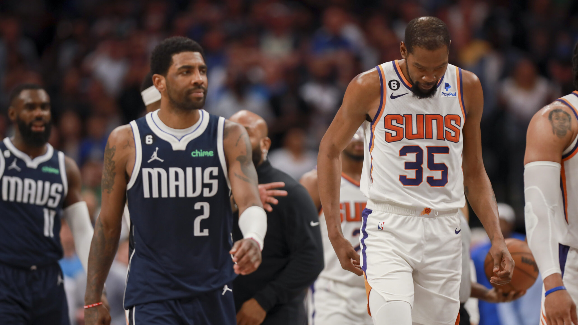 Dallas Mavericks guard Kyrie Irving (2) and Phoenix Suns forward Kevin Durant (35) walk down the court during the second half of an NBA basketball game, Sunday, March 5, 2023, in Dallas. (AP Photo/Gareth Patterson)