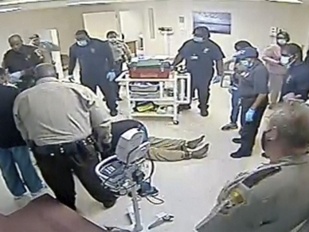 This video provided by Central State Hospital/Dinwiddie County, Va. shows a clip from surveillance camera of deputies and hospital employees appearing to administer CPR as Irvo Otieno lies on the floor at Central State Hospital, on March 6, 2023 in Petersburg, Va.  Footage obtained Tuesday, March 21, which has no audio, shows various members of  sheriff's deputies and employees attempting to restrain a handcuffed and shackled Otieno for about 20 minutes after he's led into a room at the hospital, where he was going to be admitted.   (Central State Hospital/Dinwiddie County, Va. Attorney via AP)