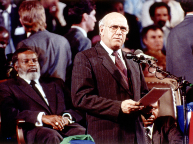 South African President F.W. de Klerk during his speech in Windhoek, Namibia, March 21, 1990, where he handed over Namibia to Namibian President Sam Nujoma, seated left,during an independence ceremony. Namibia has been ruled by South Africa since 1915. (AP Photo/Staff/Parkin)