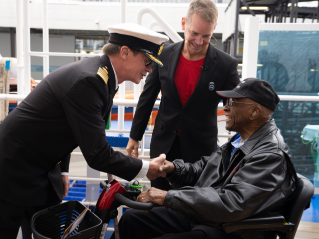 Discovery Princess Capt. John Smith and Princess Cruises President John Padgett greet retired Lt. Col. James H. Harvey III, a former Tuskegee airman, as he boarded the cruise ship on Sunday, May 21, 2023 in Seattle, to celebrate his upcoming 100th birthday. (Stephen Brashear/AP Images for Princess Cruises)