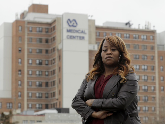 Shominicia Banks stands in front of the Kansas City Veterans Affairs Medical Center where she worked as a nurse assistant before being fired earlier this month Wednesday, March 18, 2020, in Kansas City, Mo. Banks is one of about 50 black employees who have complained about widespread discrimination at the hospital. (AP Photo/Charlie Riedel)