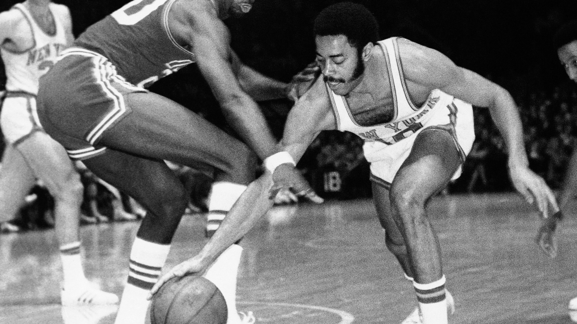 Knickerbocker Walt Frazier, 19, recovers loose ball during first period of game against Detroit in Madison Square Garden, New York, Thursday, Jan. 29, 1970. Contesting is Otto Moore, 20. (AP Photo)