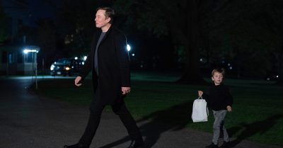 Elon Musk walks with his son at night on the White House grounds as scrutiny grows over the Department of Government Efficiency’s federal cost-cutting claims