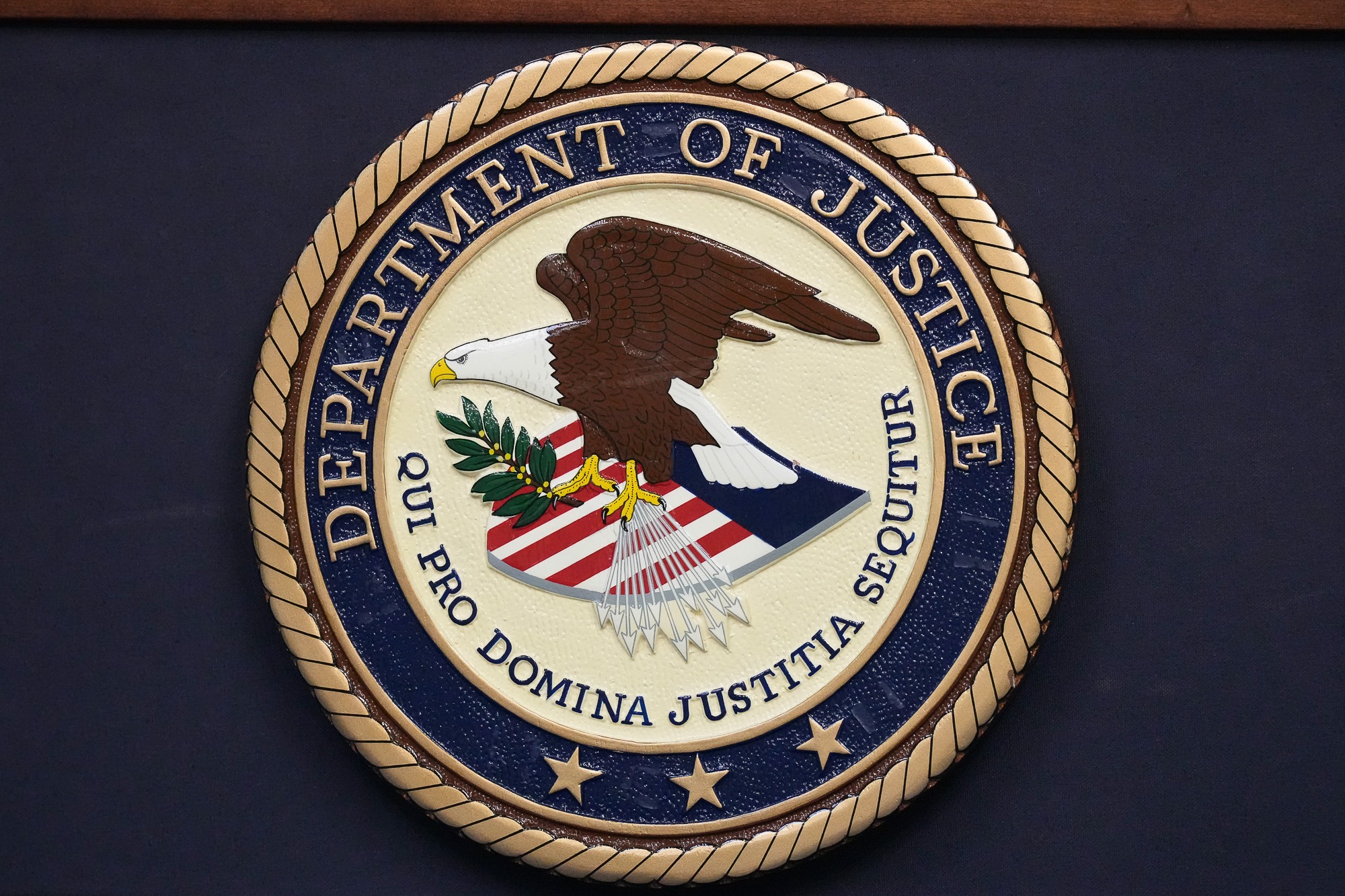Department of Justice seal displayed on a wall as the agency’s Civil Rights Division faces mass resignations under Trump’s second term