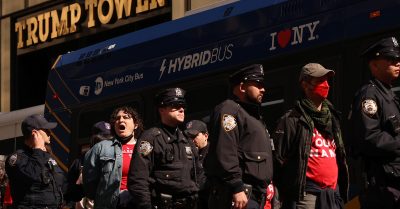 Protesters are detained by NYPD officers outside Trump Tower as concerns grow over Trump’s 2025 executive order on police militarization and federal support.
