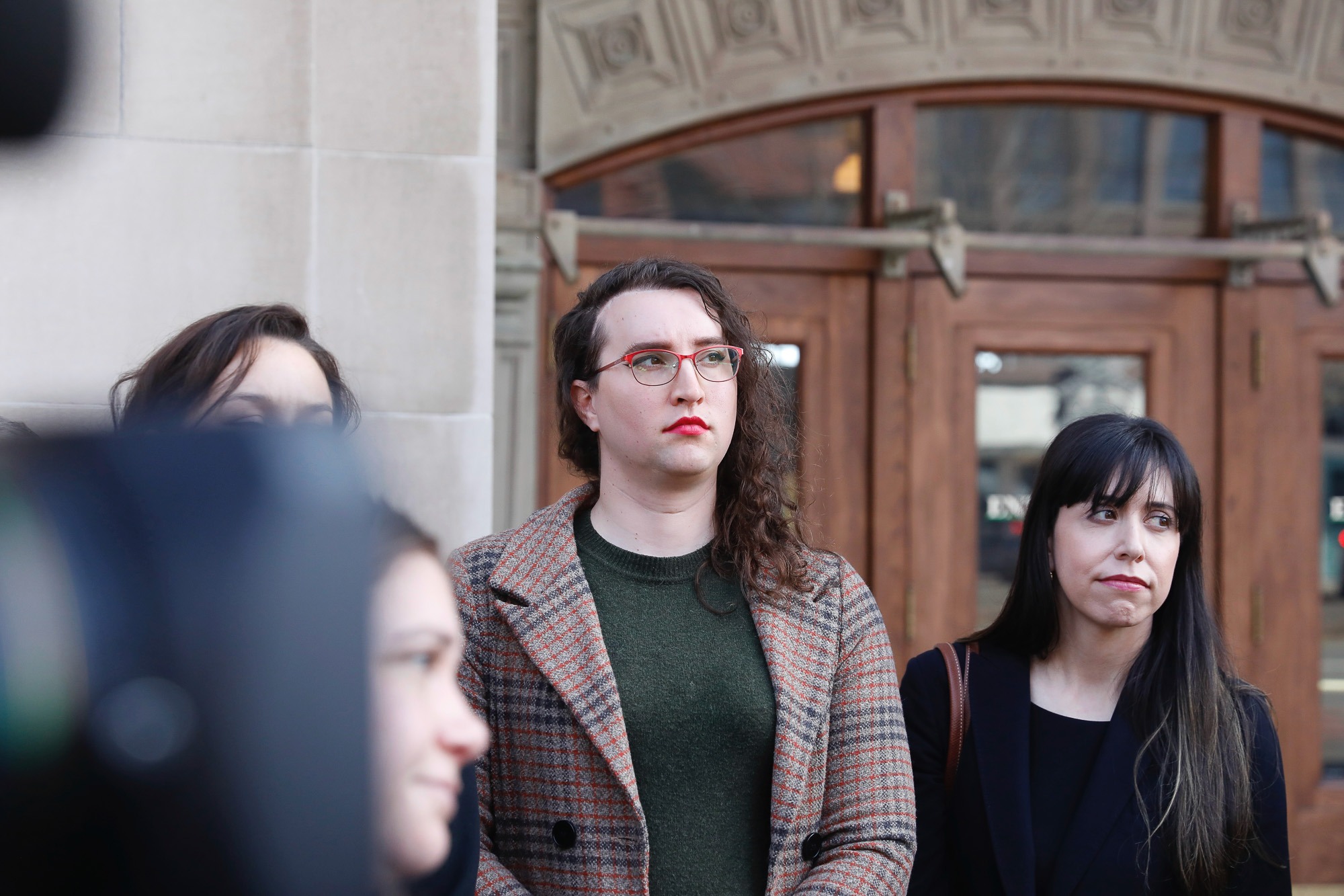 U.S. Army Sgt. 1st Class Sierra Moran, a transgender service member, listens during a press conference in Tacoma, Wash.