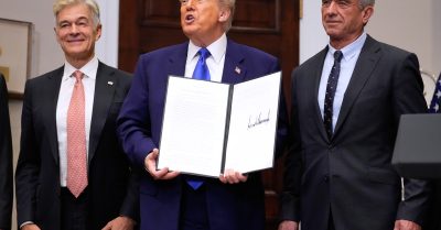 President Donald Trump, with Dr. Mehmet Oz and Robert F. Kennedy Jr., holds an executive order related to drug prices, in the Roosevelt Room of the White House.