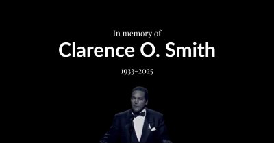 In memory of Clarence O. Smith, Essence co-founder and marketing trailblazer, shown in formal attire during a public appearance celebrating Black excellence.